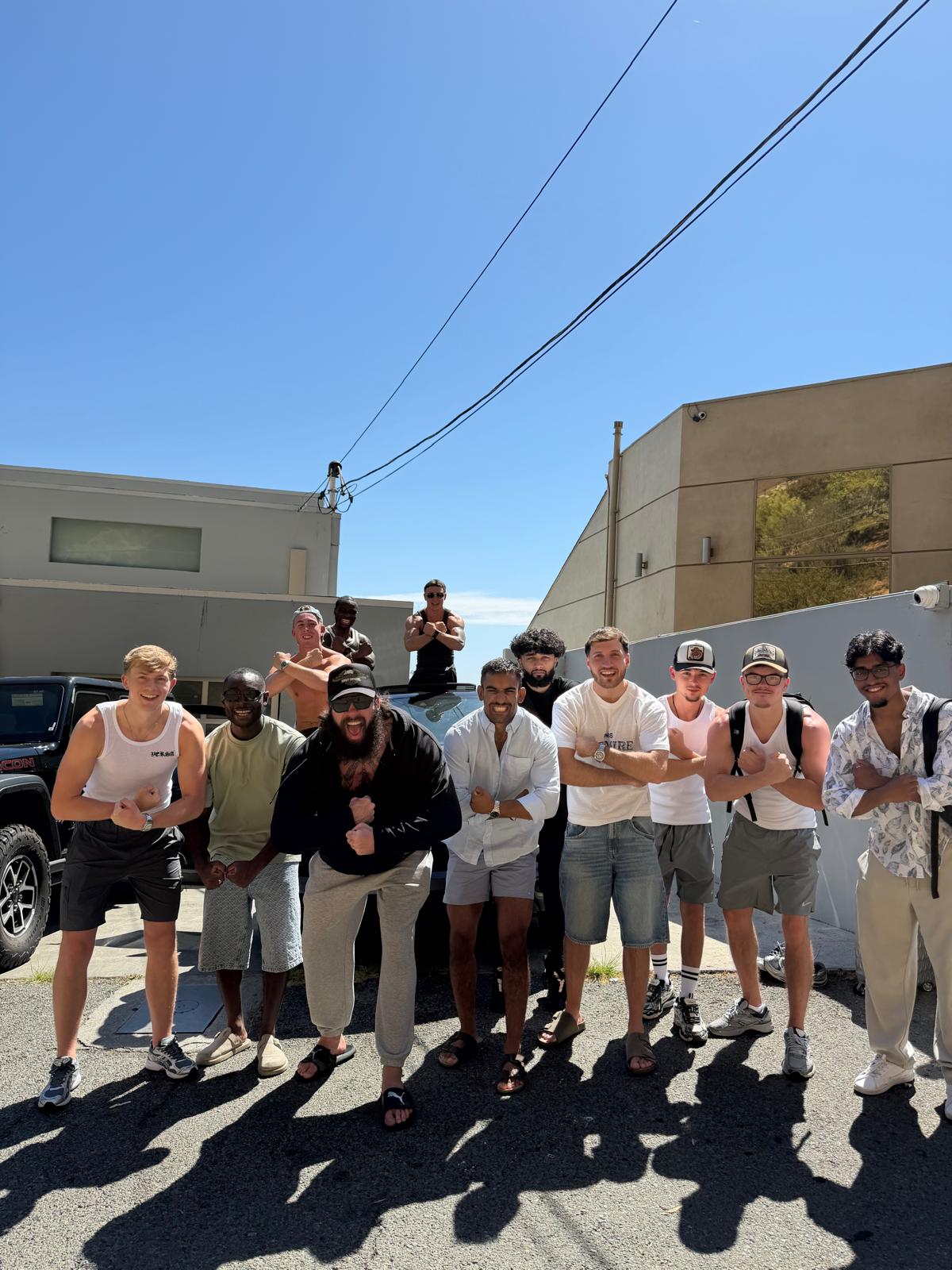The team posing together outside on a sunny day