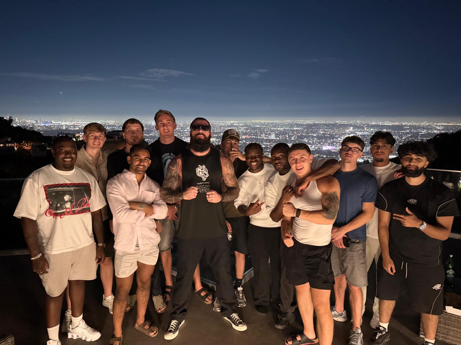 The team gathered at night overlooking the city lights