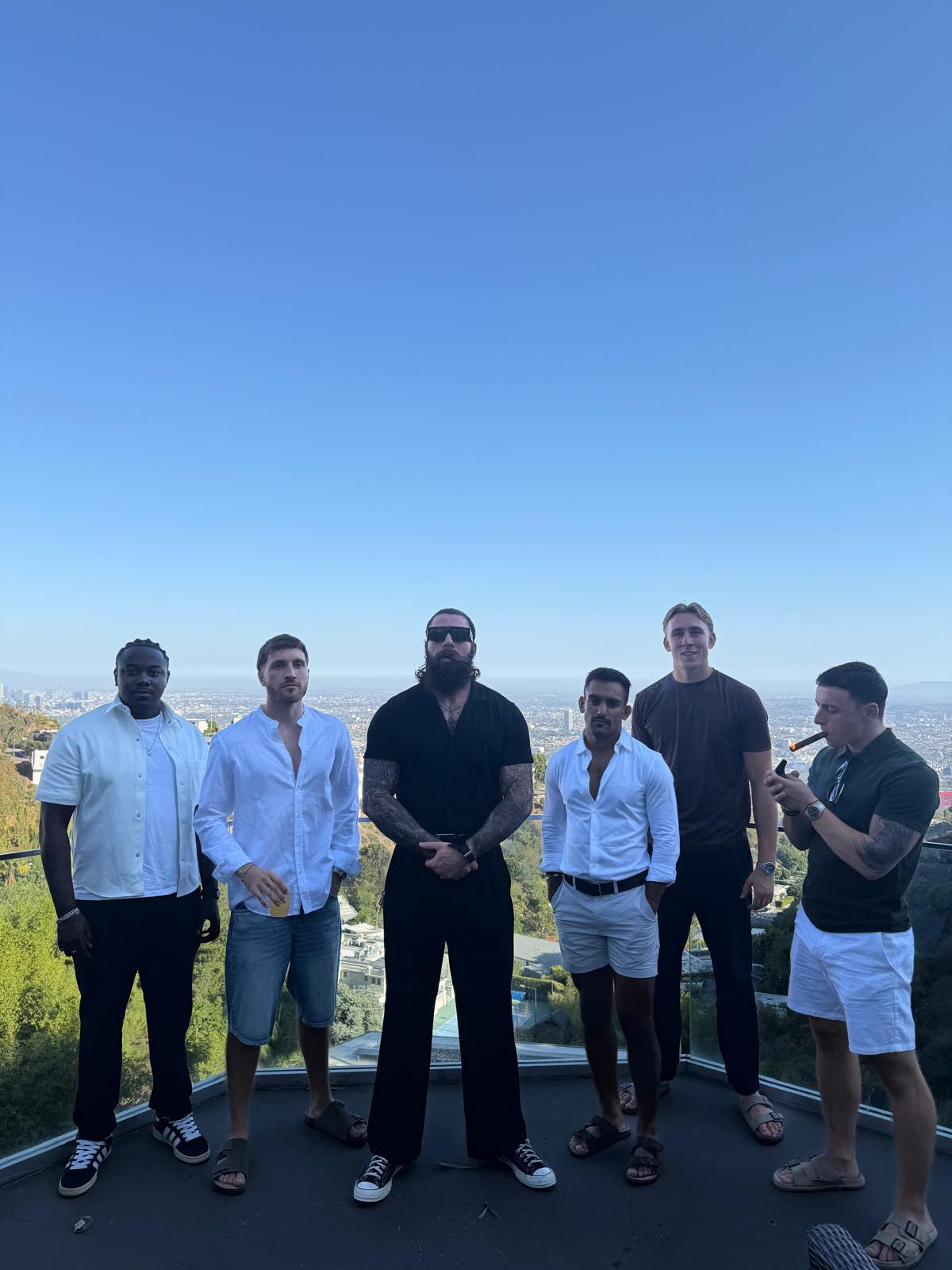 The crew standing together above the city at night